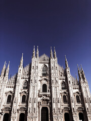 Fototapeta premium Milan Cathedral (Duomo di Milano) and monument to Victor Emmanuel II on the Piazza del Duomo in Milan, Italy. Milan Cathedral is the largest church in Italy and the main tourist attraction of Milan.