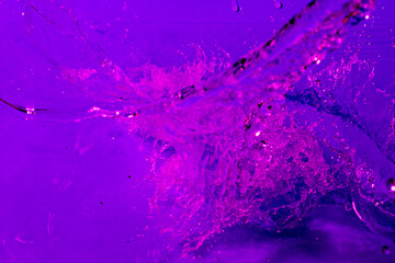 splash of water in lilac light. Abstract wallpaper