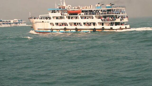 Travel Cruise Ship at deep sea travelling its destination  . Winter or Summer vacation tourist ship prople watching sightseeing of sea blue water .
