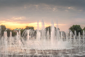 beautiful fountain in the park at sunset