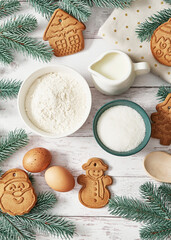 Fototapeta na wymiar Merry Christmas background tasty homemade ginger cookies. Ingredients for cooking baking, kitchen utensils, gingerbread. Happy new year greeting card. Xmas table. Fir tree, pine. Winter holidays