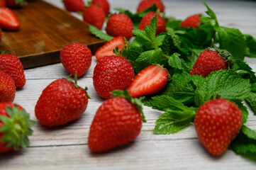 strawberries on a white table with mint sprigs