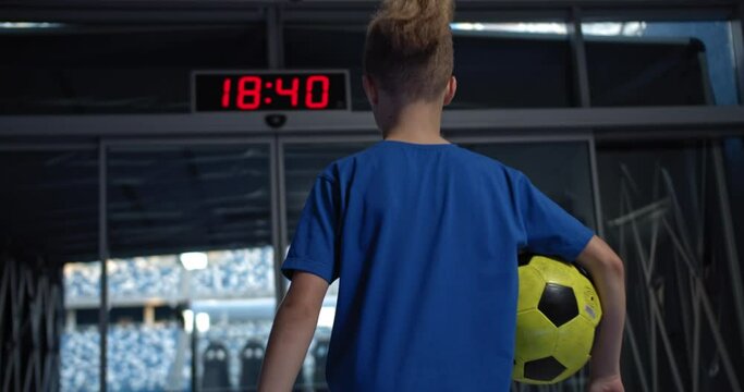 Little kid boy soccer player with ball going to empty stadium, dreaming of becoming professional player, soccer star, junior professional team, talented kids, motivational video