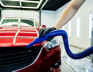 Service worker makes automatic drying of the car after washing.