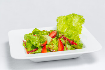 Colorful delicious Strawberry lettuce Salad with Strawberry Balsamic Dressing. Top View and Closeup views.