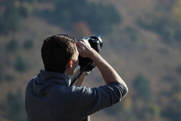 A young photographer. Photo-video filming in nature.