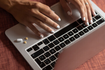 girl's hand typing on a laptop