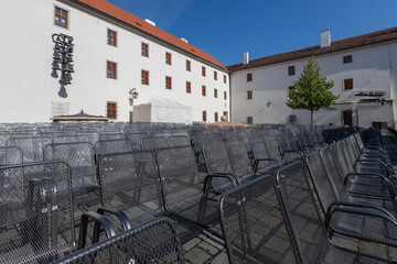 Wire chairs to sit in the courtyard in front of the stage.