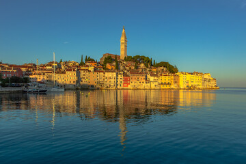 Rovinj,Istria,Croatia.View of the town situated on the coast of Adriatic Sea.Popular tourist resort and fishing port.Old town at sunrise with cobblestone streets, colorful houses and the church tower