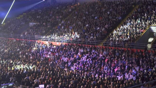 Crowd of people applause at the stadium during business forum