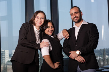 Business people during meeting in board room. Colleagues at business meeting in conference room. Always brainstorming. Smiling colleagues working together at desk in office discussing papers