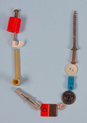 Letter of the alphabet built with small miscellaneous objects