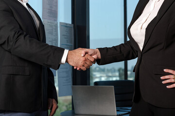 Businessman and businesswoman make handshakes, finishing up meeting. Handshake colleagues in the...