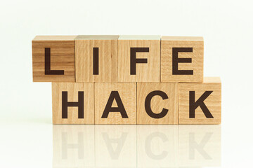Wooden block with words LIFE HACKS on the white background, concept background.
