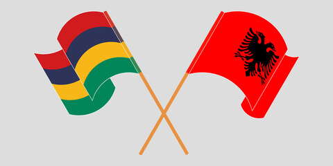 Crossed and waving flags of Mauritius and Albania