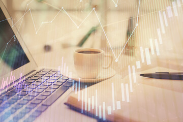 Double exposure of financial chart drawing and desktop with coffee and items on table background. Concept of forex market trading