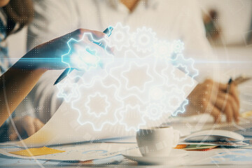 Double exposure of business theme drawing over people taking notes background. Concept of financial world