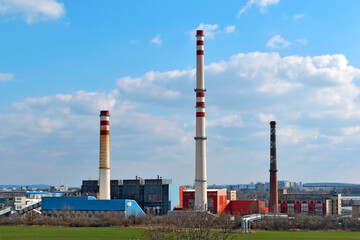 Industrial landscape. Thermal power plant with smoking from high chimneys. Ecological danger.