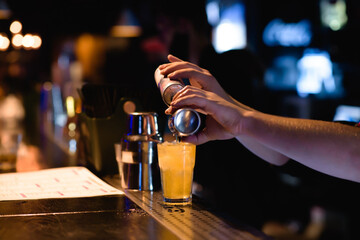 Bright cocktails - shots at the bar. Colorful footage in a nightclub. Alcoholic drink of different colors. Nightlife scene. Shots at the bar table. Several glasses of alcohol 