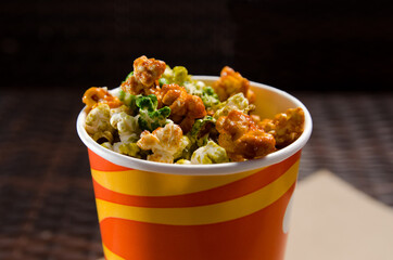 multicolored sweet popcorn in paper disposable cup