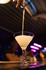 Bright cocktails - shots at the bar. Colorful footage in a nightclub. Alcoholic drink of different colors. Nightlife scene. Shots at the bar table. Several glasses of alcohol 