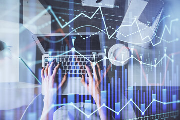 Double exposure of woman hands working on computer and forex chart hologram drawing. Top View. Financial analysis concept.