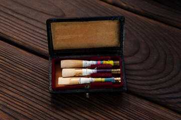 Set of oboe reeds on a wooden surface