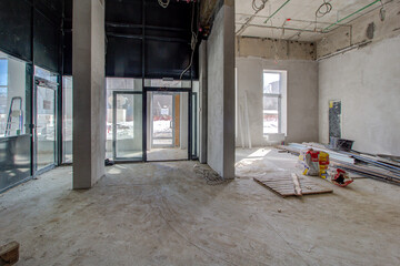Corridor of new residential building under construction view. Unfinished corridor in interior of construction site inside of new modern residential building. Long corridor and room with construction © MDF