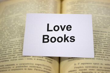 Love books written in white note on open books