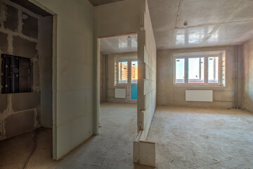 Unfinished construction empty room. Walls from lightweight aggregate concrete blocks with empty...