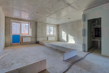 Unfinished construction empty room. Walls from lightweight aggregate concrete blocks with empty...