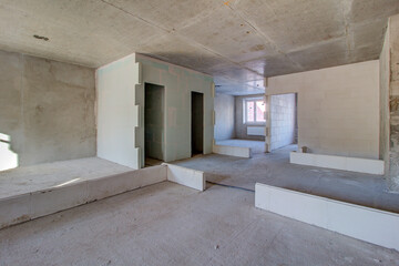Unfinished construction empty room. Walls from lightweight aggregate concrete blocks with empty...