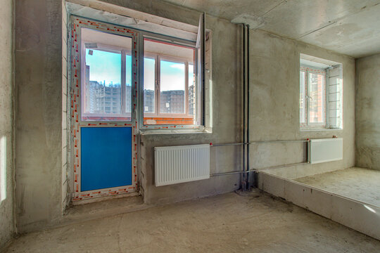 Unfinished construction empty room. Walls from lightweight aggregate concrete blocks with empty doorframes, unfinished interior, house under construction