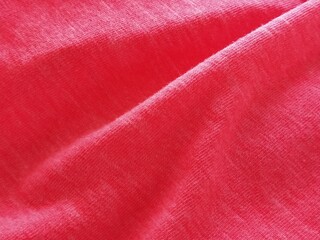 Bright pink or magenta polyester fabric, wrinkled or folded carelessly. Saturated background....