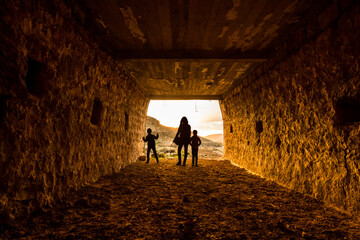 silhouette of children  in a tunnel like old ruined stone house in mardin