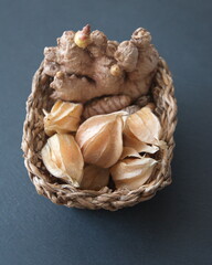  Ginger and  turmeric roots, Physalis peruviana fruits, Chestnut, sweet chesnut (castanea sativa ), Spanish Chestnut on dark grey stone background