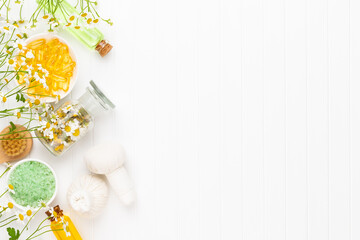 Spa still life with aromatherapy chamomile, herbal oil, soap, sea salt.