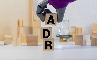 Letter block in word ADR Abbreviation of adverse drug reaction on wood background