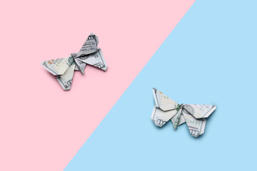 Origami butterflies made of dollar banknotes on color background