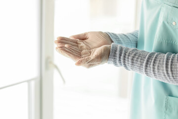 Doctor with medical gloves in clinic