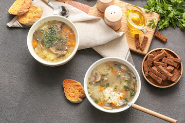Bowls of tasty rice soup on dark background