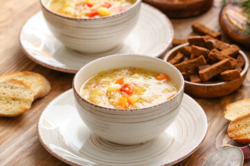 Bowl of tasty rice soup on table