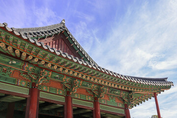 traditional multicolored paintwork on wooden buildings of Korea called "Dancheong" and blue Autumn Sky.