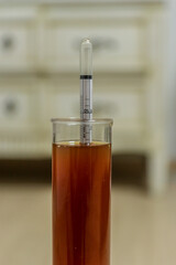 We are measuring the gravity of beer wort in a brew.