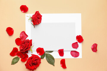 Beautiful red roses and blank card on color background