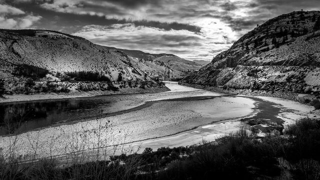 Black and White Photo of Sunset over the Winter Landscape of the semi arid Thompson River Valley and the Trans Canada Highway in central British Columbia, Canada