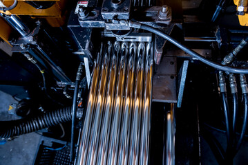 Automatic band saw machine with water coolant cutting metal pipes.