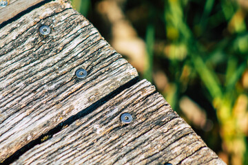 Closeup of a rustic wooden bridge spanning a pond in the french countryside in the fall