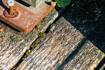 Closeup of a rustic wooden bridge spanning a pond in the french countryside in the fall