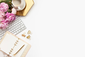 Top view of stylish office desk accessories with keyboard and cup of cappuccino on the gold tray.
